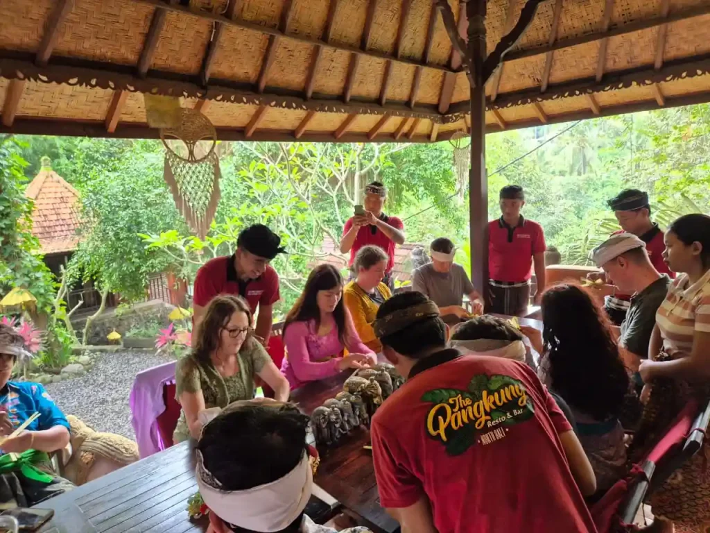 Tamu membuat canang sari di Bulian Homestay Bali bersama warga lokal dalam suasana desa yang adem
