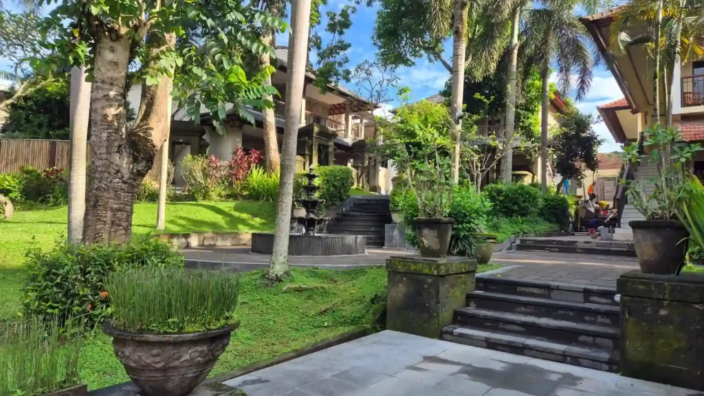 Jalan setapak yang rindang dan dipenuhi pepohonan tropis di area Champlung Sari Hotel Villa & Spa Ubud.